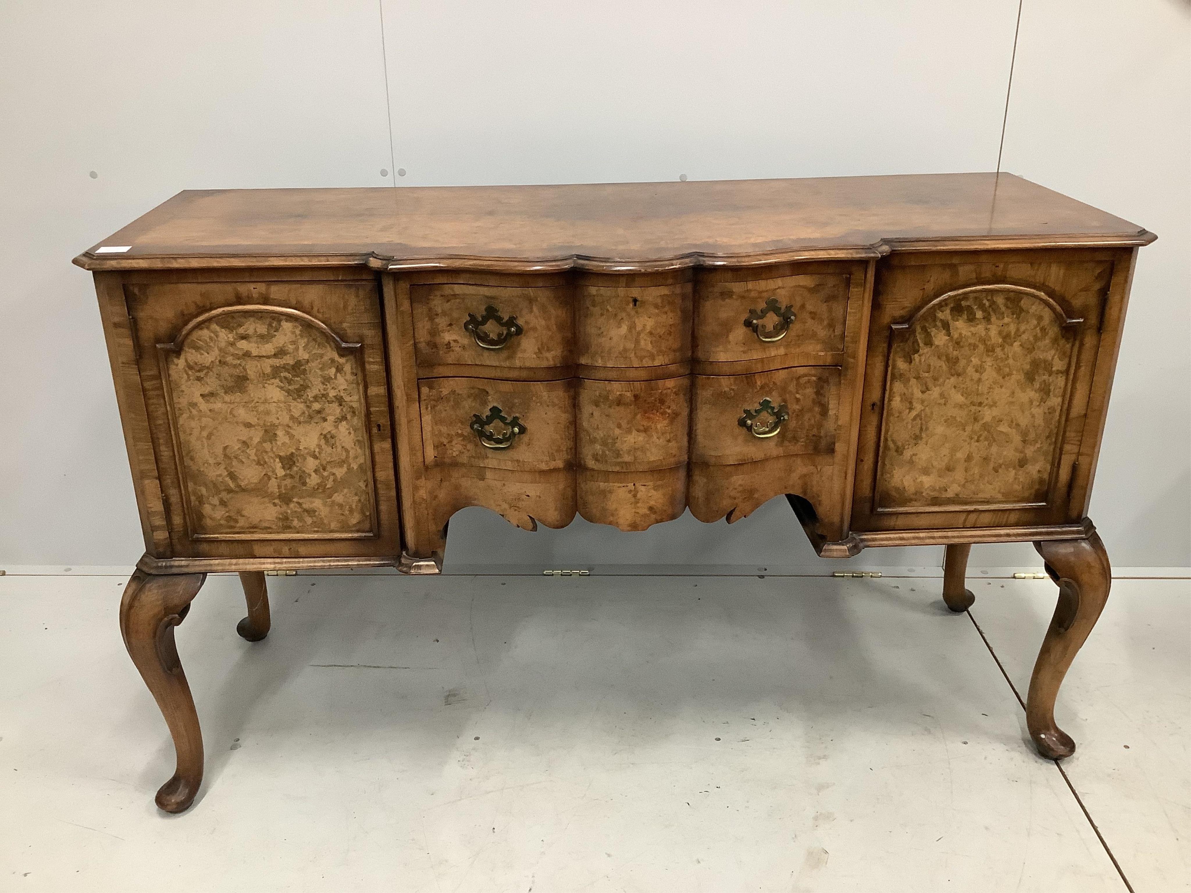 A Queen Anne Revival serpentine walnut sideboard, width 152cm, depth 59cm, height 93cm. Condition - fair